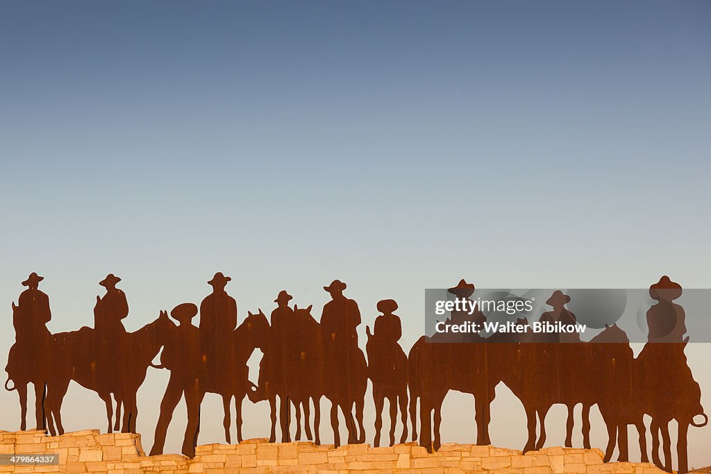 Dodge City, cowboy silhouette, dawn