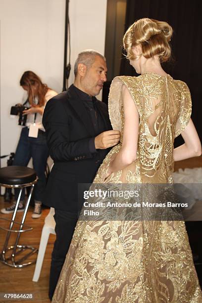 Elie Saab prepares model backstage prior to Elie Saab show as part of Paris Fashion Week Haute-Couture Fall/Winter 2015/2016 on July 8, 2015 in...