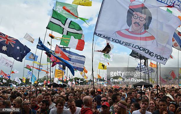 Flags in the crowd prior to Lionel Richie's performance on the Pyramid stage during the third day of Glastonbury Festival at Worthy Farm, Pilton on...