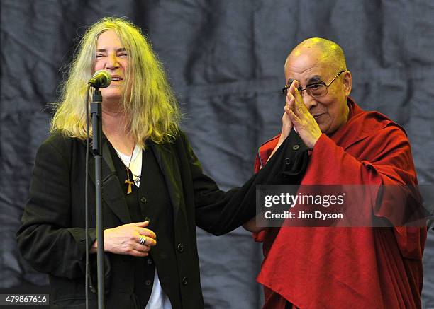 His holiness the Dalai Lama joins Patti Smith on the Pyramid stage during the third day of the Glastonbury Festival at Worthy Farm, Pilton on June...