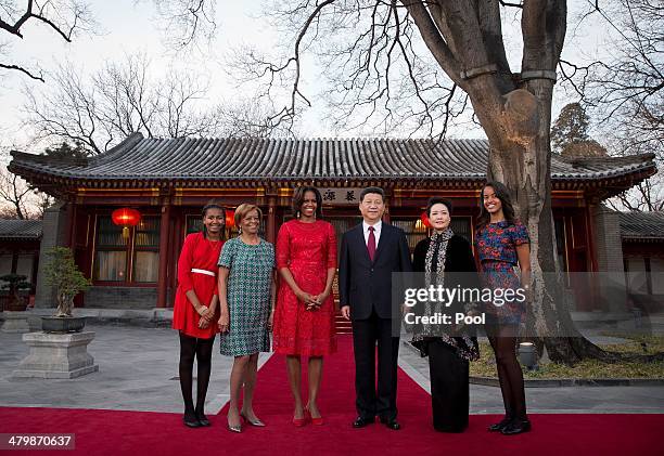 First lady Michelle Obama, her daughters Malia and Sasha and her mother Marian Robinson share a light moment with Chinese President Xi Jinping and...