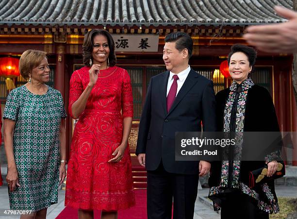 First lady Michelle Obama and her mother Marian Robinson share a light moment with Chinese President Xi Jinping and his wife Peng Liyuan after a...