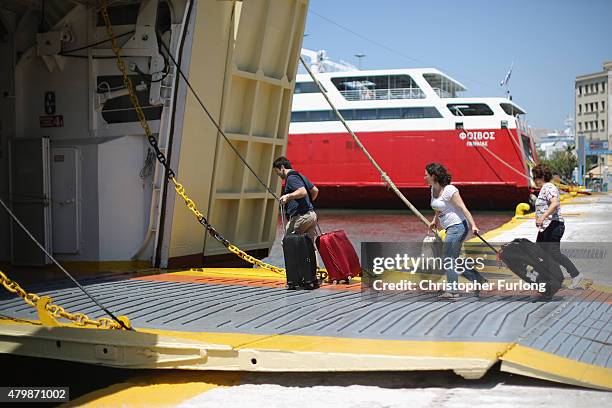 Tourists rush to board an island ferry at the Piraeus terminal on July 8, 2015 in Athens, Greece. Eurozone leaders have offered the Greek government...