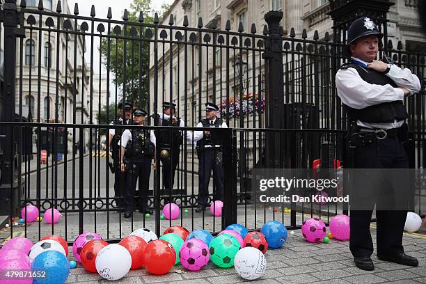 Anti austerity protesters throw balls towards Downing Street after the Chancellor of the Exchequer George Osborne left 11 Downing Street on July 8,...