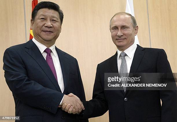 Russian President Vladimir Putin shakes hands with his China's counterpart Xi Jinping during their meeting in Ufa on July 8, 2015 ahead of the start...