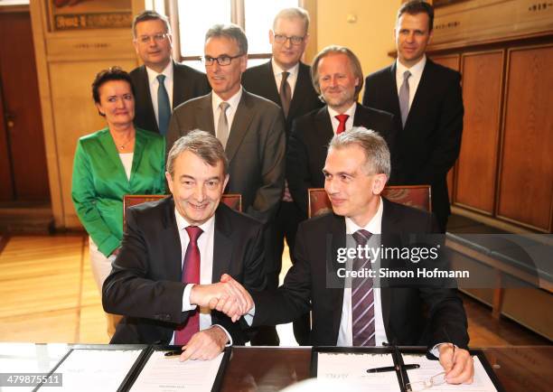 President Wolfgang Niersbach and Mayor of Frankfurt Peter Feldmann shake hands during the announcement of the new DFB Performance Center on March 21,...