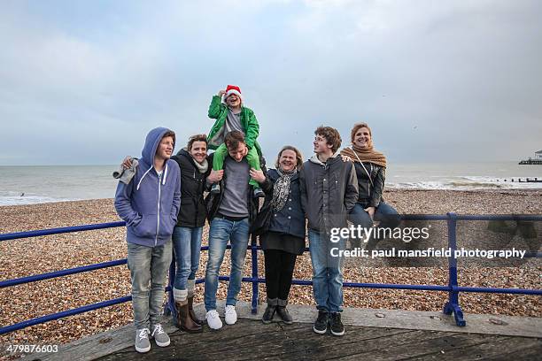 family at seaside on wintry day - young teen girl beach stock pictures, royalty-free photos & images