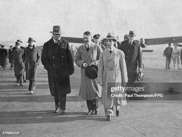 German leader Adolf Hitler and politician Joseph Goebbels arrive at Tempelhof Airport in Berlin, circa 1933. On the right is Ernst Hanfstaengl , a...