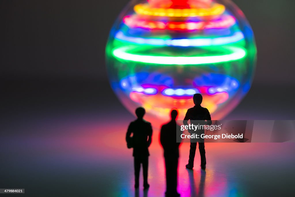 Men contemplating sphere