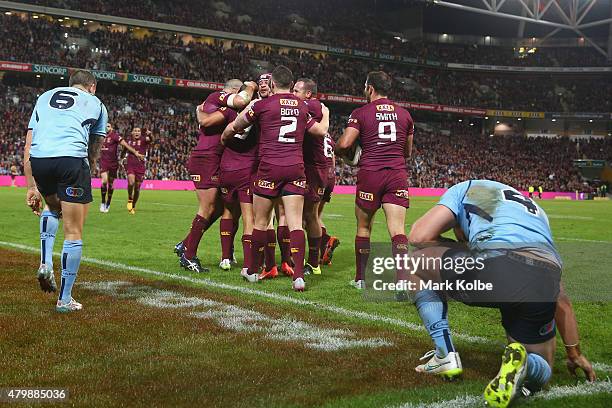 The Maroons celebrate with Will Chambers of the Maroons during game three of the State of Origin series between the Queensland Maroons and the New...