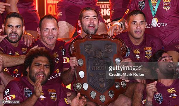 Greg Inglis, Sam Thaiday, Matthew Scott, Cameron Smith, Justin Hodges and Johnathan Thurston of the Maroons celebrate with the State of Origin shield...