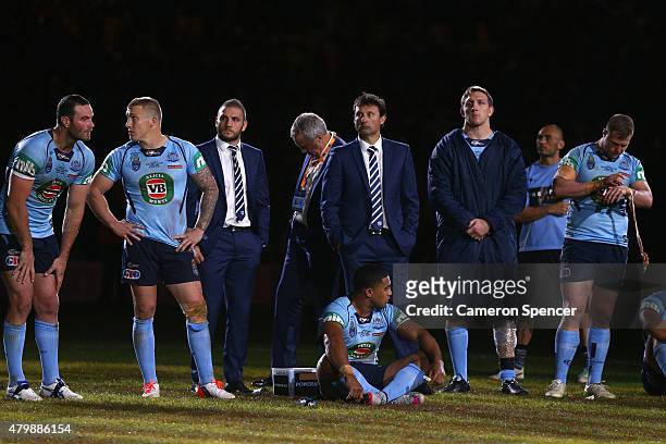 Blues coach Laurie Daley and his players look dejected after losing game three of the State of Origin series between the Queensland Maroons and the...