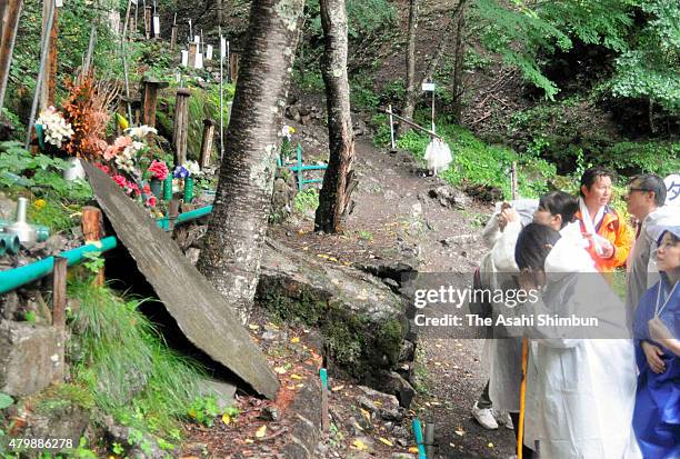 Japan Airlines employees pray for the victims of JAL 123 as they climb Mount Osutaka to remember the crash on July 8, 2015 in Ueno, Gunma, Japan....