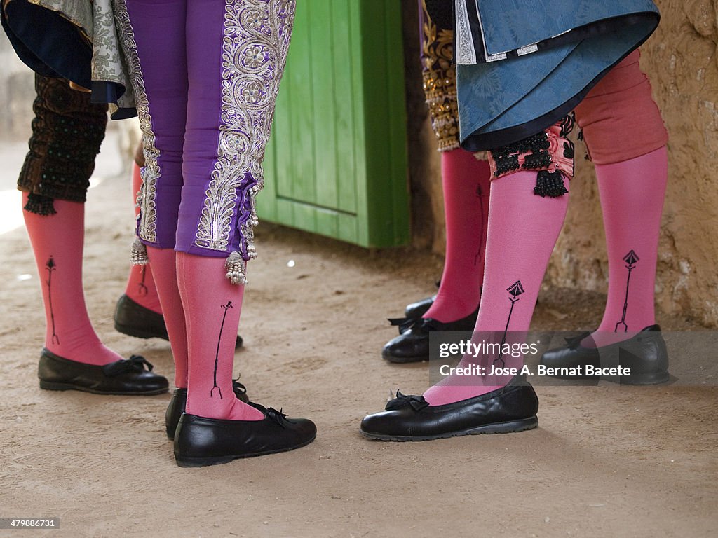 Bullfighters' legs in the door of the bullring