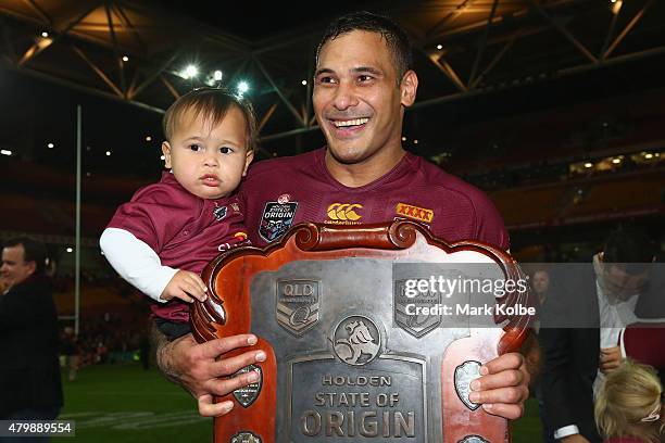 Justin Hodges of the Maroons poses with his son Carter as he holds the shield during game three of the State of Origin series between the Queensland...