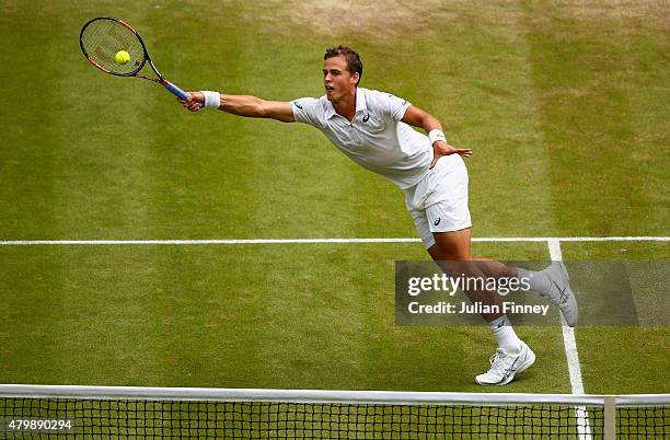 Vasek Pospisil of Canada plays a forehand in his Gentlemens Singles Quarter Final match against Andy Murray of Great Britain during day nine of the...