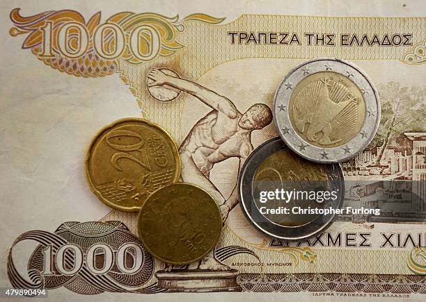 In this photo illustration Euro coins lay on a 1000 Drachma note, the currency in Greece before the Euro, on July 8, 2015 in Athens, Greece. Eurozone...