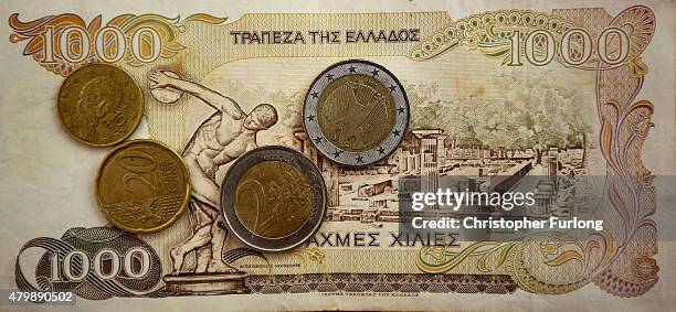 In this photo illustration Euro coins lay on a 1000 Drachma note, the currency in Greece before the Euro, on July 8, 2015 in Athens, Greece. Eurozone...