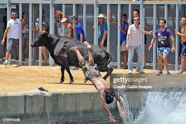 Locals and tourists take part in the 'Toros Al Mar' on July 7, 2015 in Denia, Spain. 'Toros la Mar' is part of the folk festival 'Santisima Sangre.'...