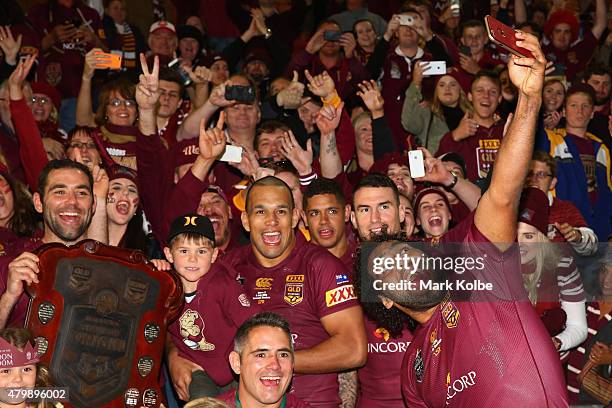 Sam Thaiday of the Maroons takes a selfie as the Maroons pose for a team photo during game three of the State of Origin series between the Queensland...