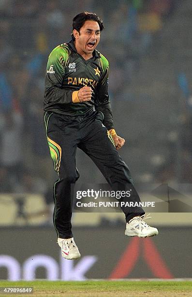 Pakistan bowler Saeed Ajmal celebrates after taking the wicket of Indian batsman Rohit Sharma during the ICC World Twenty20 tournament cricket match...