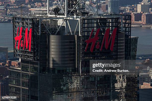 Logos are seen atop the Four Times Square building, as seen from the top of Rockefeller Center on March 21, 2014 in New York City. After a cold,...