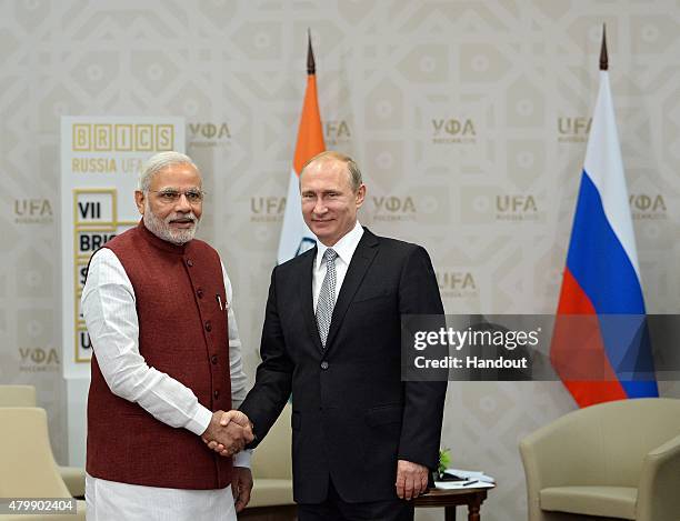 In this handout image supplied by Host Photo Agency / RIA Novosti, President of the Russian Federation Vladimir Putin meets Prime Minister of the...