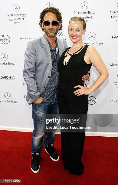 Falk-Willy Wild and Vaile Fuchs attend the Rebekka Ruetz show during the Mercedes-Benz Fashion Week Berlin Spring/Summer 2016 at Brandenburg Gate on...