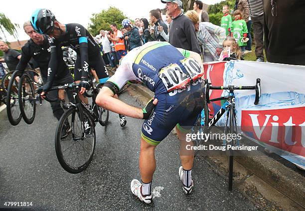 Michael Albasini of Switzerland and Orica Greenedge picks himself up following a crash 25km from the finish during stage five of the 2015 Tour de...