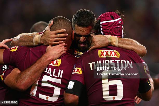 Greg Inglis of the Maroons congratulates Josh Papalii of the Maroons after scoring a try with team mate Johnathan Thurston during game three of the...