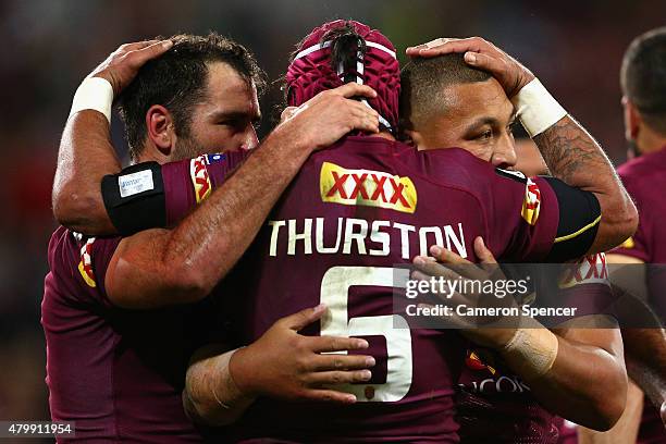 Maroons captain Cameron Smith congratulates Josh Papalii of the Maroons after scoring a try with team mate Johnathan Thurston during game three of...