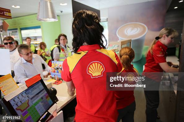 Shells In Store Employees Employees serve customers in the store at Royal Dutch Shell Plc's ...