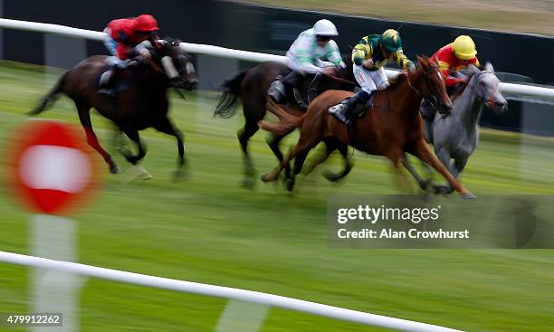 Shane Kelly riding Toxaris win The Trevor Buckland Memorial Fillies' Handicap Stakes at Lingfield racecourse on July 08, 2015 in Lingfield, England.