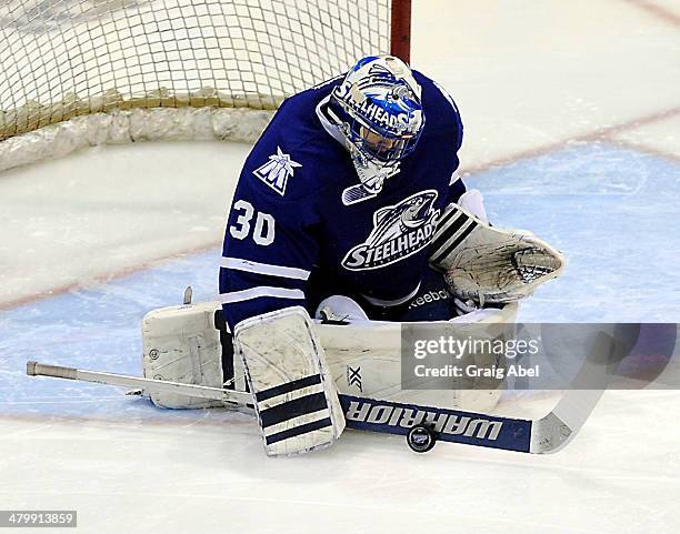 Spencer Martin of the Mississauga Steelheads stops a shot against the Kingston Frontenacs during game action on March 16, 2014 at the Hershey Centre...