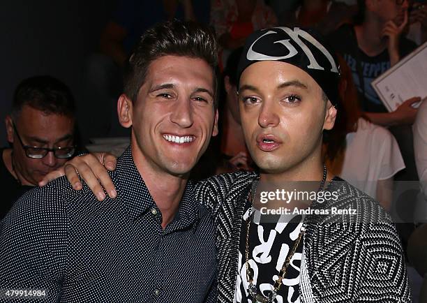 Julian F.M. Stoeckel and a guest attend the Rebekka Ruetz show during the Mercedes-Benz Fashion Week Berlin Spring/Summer 2016 at Brandenburg Gate on...