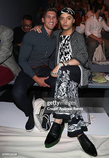 Julian F.M. Stoeckel and a guest attend the Rebekka Ruetz show during the Mercedes-Benz Fashion Week Berlin Spring/Summer 2016 at Brandenburg Gate on...