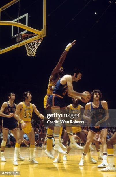 Wilt Chamberlain of the Los Angeles Lakers defends against Jerry Lucas of the New York Knicks as Pat Riley of the Lakers and Phil Jackson of the...