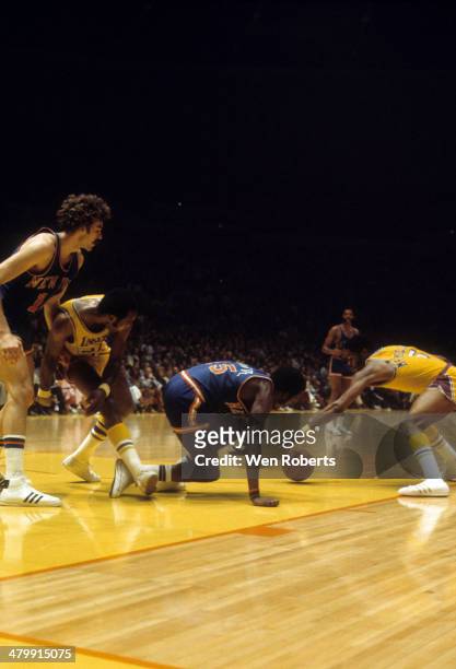 Jim McMillian of the Los Angeles Lakers and Earl Monroe of the New York Knicks go for the lose ball as Happy Hairston of the Lakers blocks out Phil...