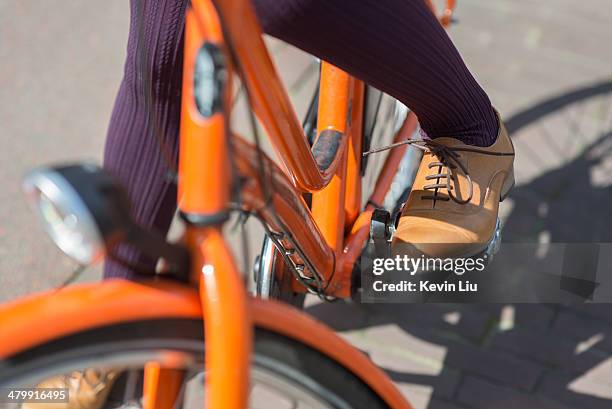 Lady Riding Orange Bike In Leather Shoes, Foto de stock