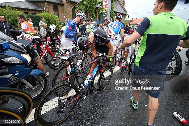 Riders collect themselves after being involved in a crash with 25km remaing in stage five of the 2015 Tour de France from Arras to Amiens Metropole...