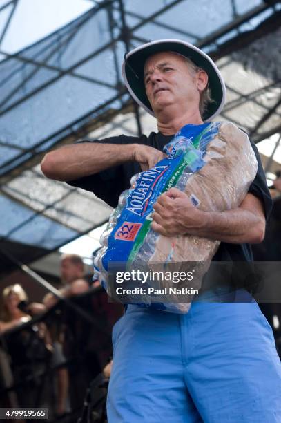 Actor Bill Murray clowns around as he hands out water bottles at Eric Clapton's Crossroads Guitar Festival, held at Toyota Park, Bridgeview,...