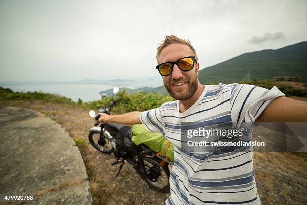 viaggiatore da motociclista viaggio prendendo un selfie - mare moto foto e immagini stock