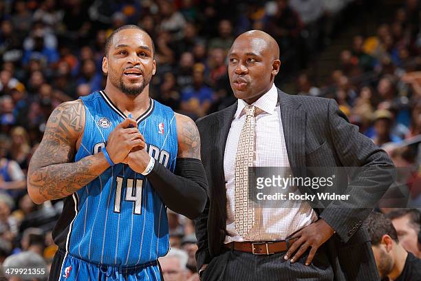 Head coach Jacque Vaughn talks to Jameer Nelson of the Orlando Magic while facing the Golden State Warriors on March 18, 2014 at Oracle Arena in...
