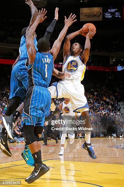 Jordan Crawford of the Golden State Warriors shoots against Doron Lamb of the Orlando Magic on March 18, 2014 at Oracle Arena in Oakland, California....