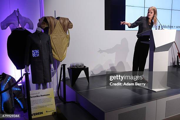 Veronika Aumann speaks next to her design group Screenstoff's textile display clothing at the Microsoft Wearable IT Fashion Tech Award during...