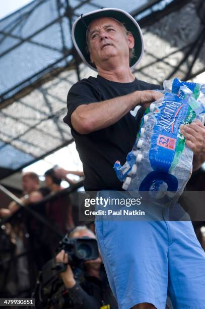 Actor Bill Murray clowns around as he hands out water bottles at Eric Clapton's Crossroads Guitar Festival, held at Toyota Park, Bridgeview,...