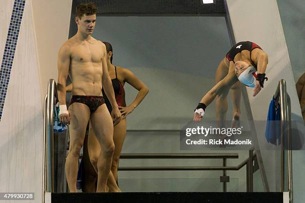 Vincent Riendeau watches as teammate Meaghan Benefito dives from the platform. Team Canada diving team practices at the Pan Am Aquatic Centre in...