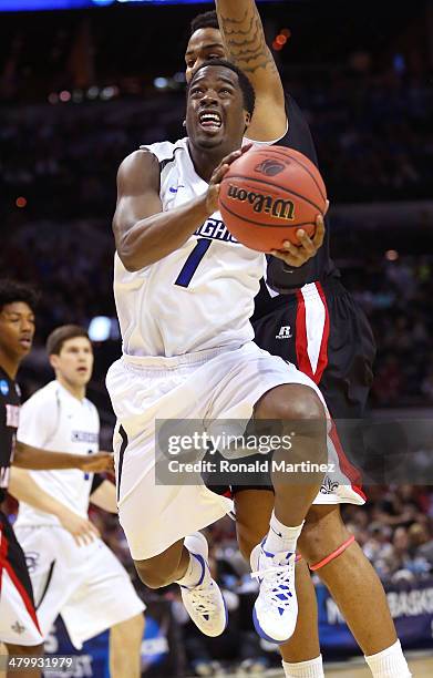 Austin Chatman of the Creighton Bluejays drives to the basket against Shawn Long of Louisiana Lafayette Ragin Cajuns in the first half during the...