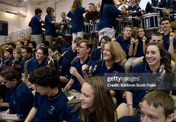 The band moves in the bleachers as they perform for the school assembly. The Legacy High School Lightning Marching Band is honored during a school...