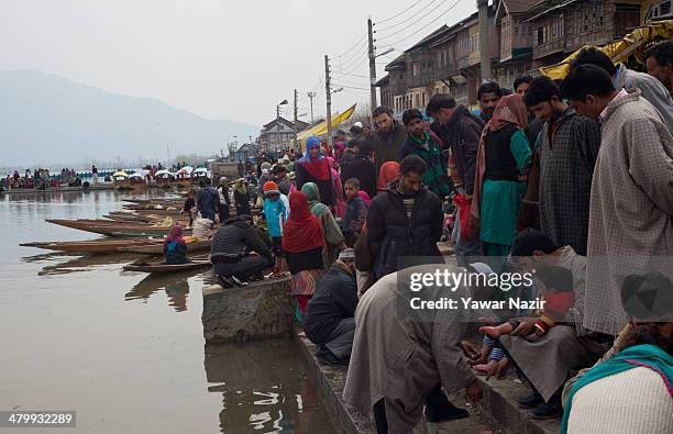 Kashmiri patients receive leech therapy from practitioners on the bank of Dal lake on March 21 in Srinagar, the summer capital of Indian administered...